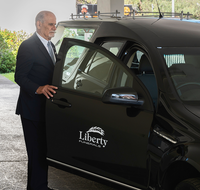 Liberty funeral director entering a hearse