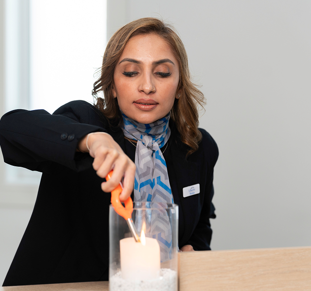Liberty funeral director lighting a candle