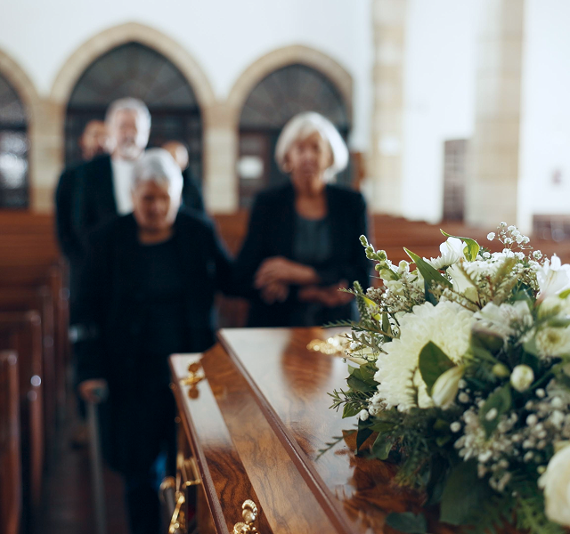 mourners with coffin